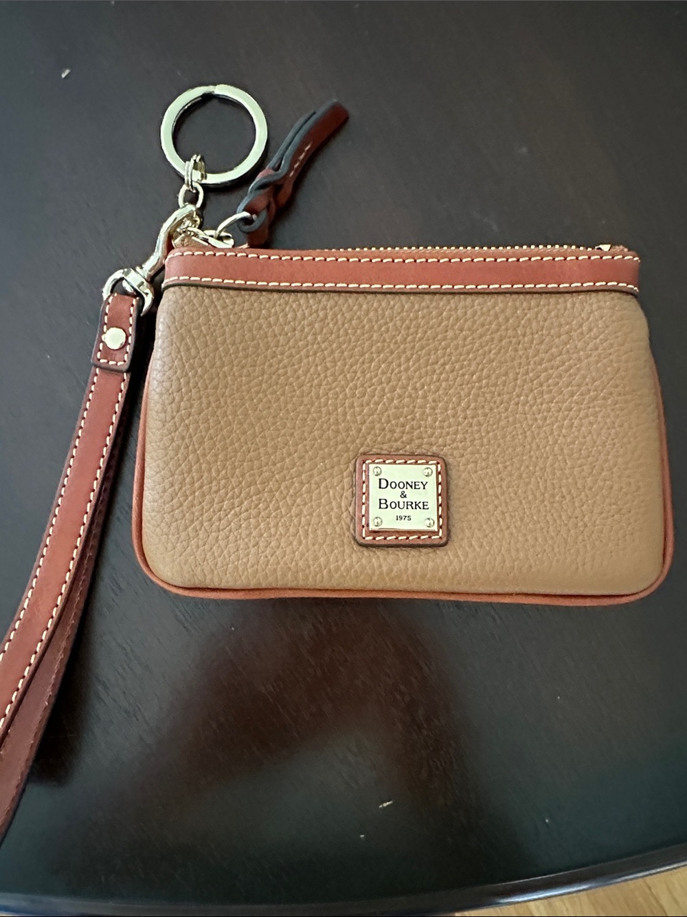 Dooney & Bourke Tan Pebbled Leather Medium Wristlet in camel.